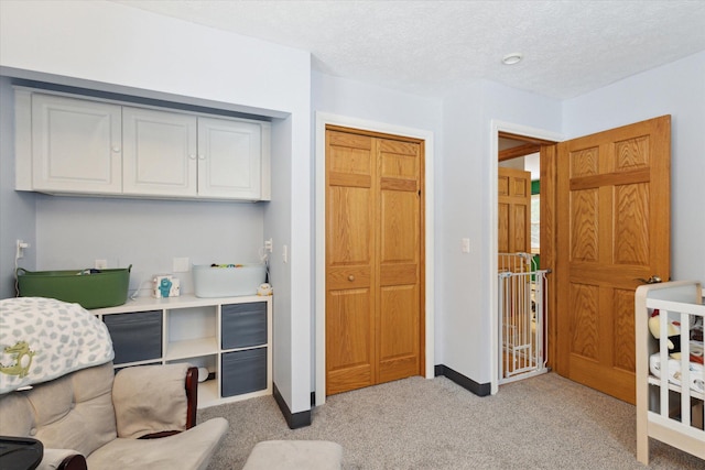 interior space with a textured ceiling and light colored carpet