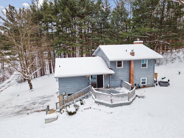 view of snow covered rear of property