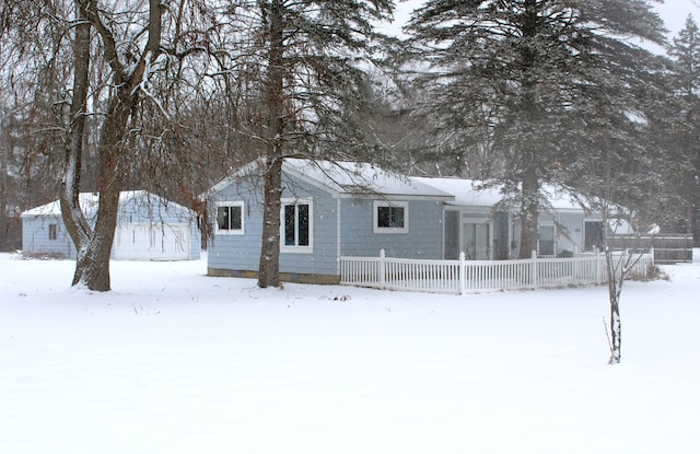 view of snow covered back of property