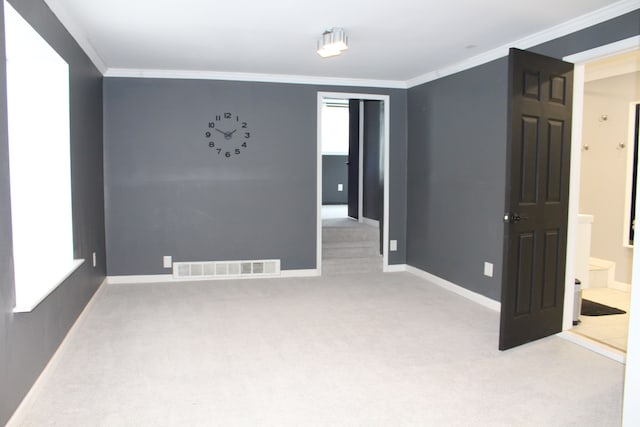 carpeted spare room with ornamental molding