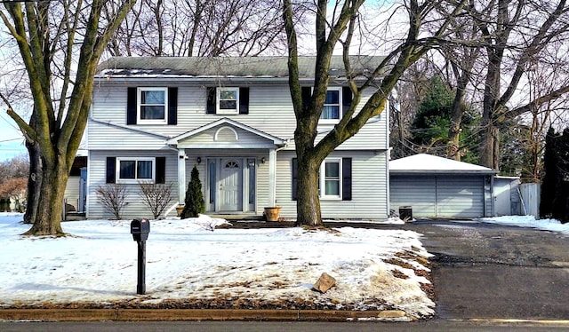 colonial inspired home featuring an outbuilding and a detached garage