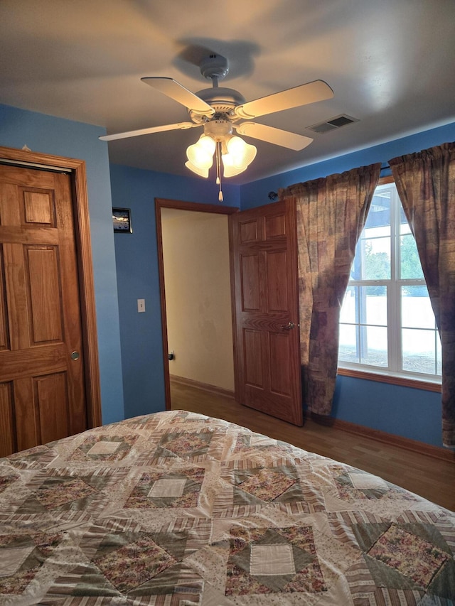 unfurnished bedroom with ceiling fan and wood-type flooring