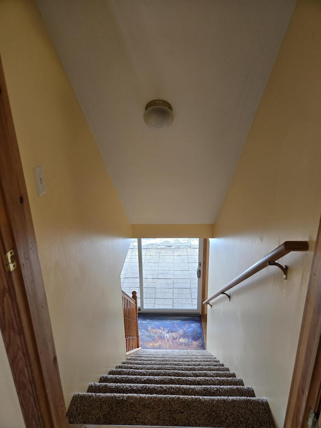 stairs with vaulted ceiling