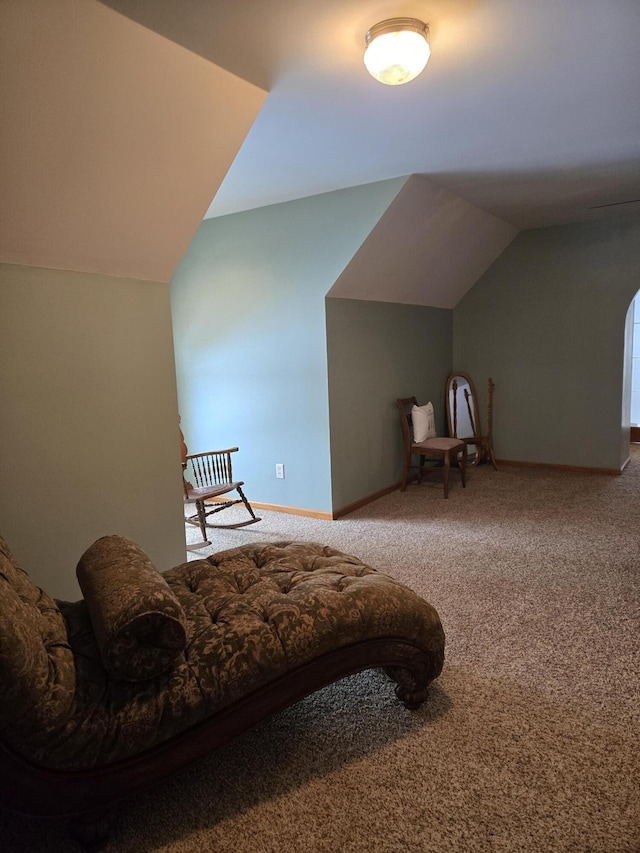 living area featuring vaulted ceiling and carpet floors