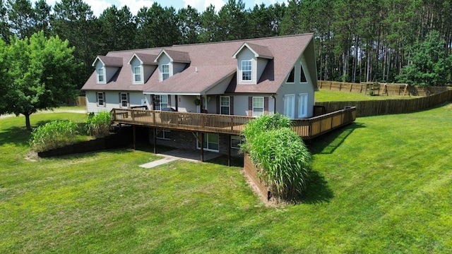 back of property with a deck and a lawn