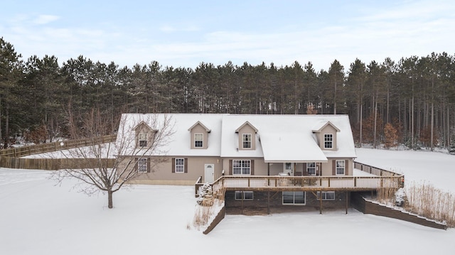 snow covered property with a wooden deck