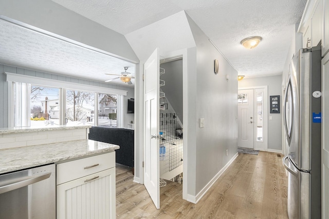 kitchen featuring light hardwood / wood-style flooring, stainless steel appliances, and white cabinetry