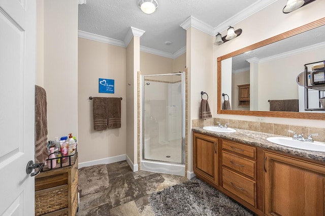 bathroom featuring a shower with shower door, vanity, crown molding, and a textured ceiling