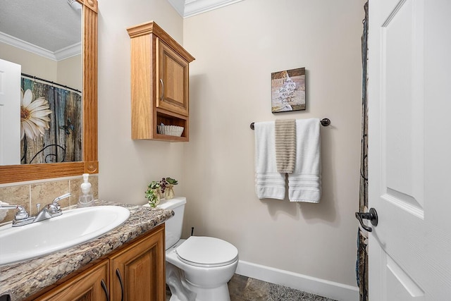 bathroom featuring toilet, crown molding, and vanity