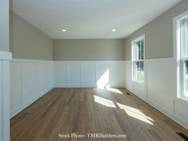 unfurnished room with light wood-type flooring