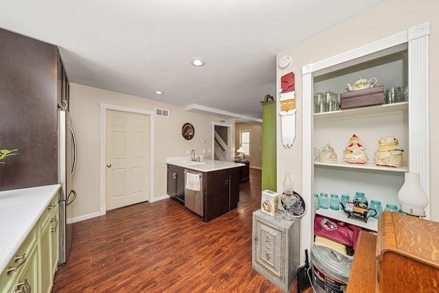 kitchen with dark wood-type flooring, sink, green cabinetry, and stainless steel appliances