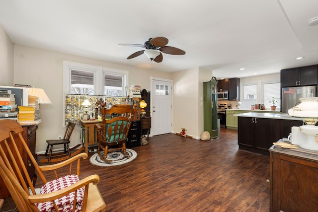 interior space featuring ceiling fan, appliances with stainless steel finishes, dark hardwood / wood-style floors, and dark brown cabinetry