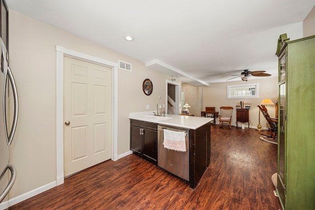 kitchen featuring ceiling fan, kitchen peninsula, sink, appliances with stainless steel finishes, and dark wood-type flooring