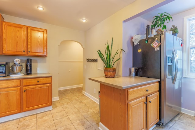 kitchen featuring appliances with stainless steel finishes and light tile patterned flooring