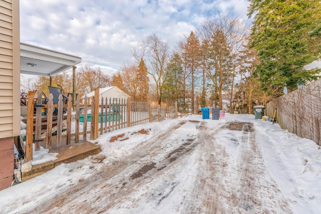 snow covered deck featuring a fenced in pool