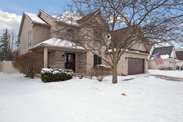 traditional-style home featuring an attached garage and brick siding