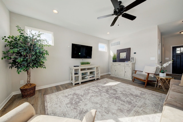 living room featuring hardwood / wood-style flooring and ceiling fan