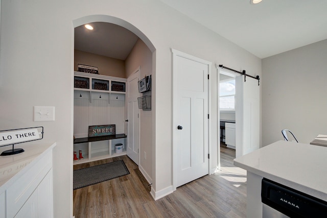 mudroom featuring light wood-type flooring and a barn door