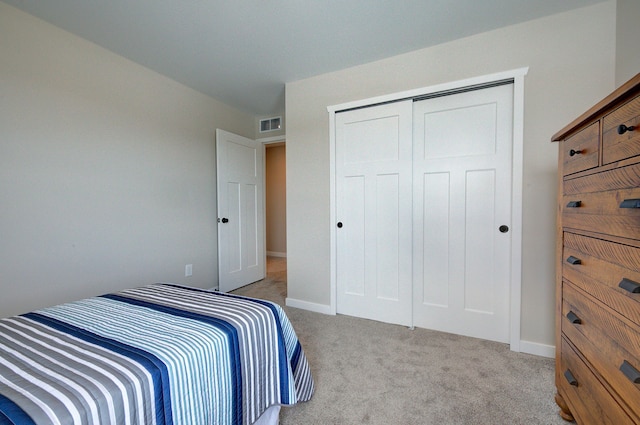 bedroom with light colored carpet and a closet