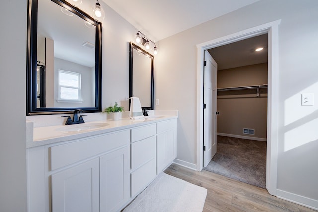 bathroom with hardwood / wood-style floors and vanity