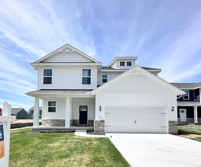 view of front facade featuring a garage, a front yard, and a porch