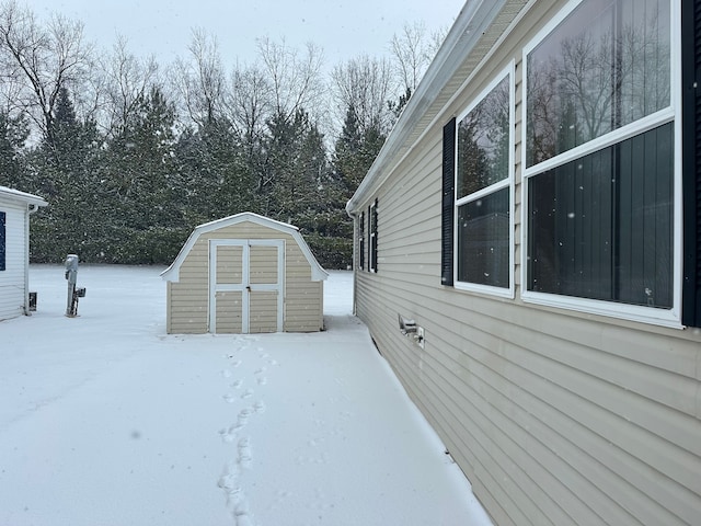 snowy yard with a storage unit