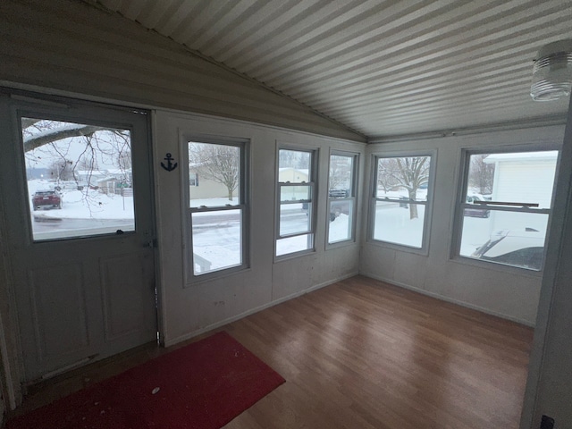 unfurnished sunroom featuring lofted ceiling