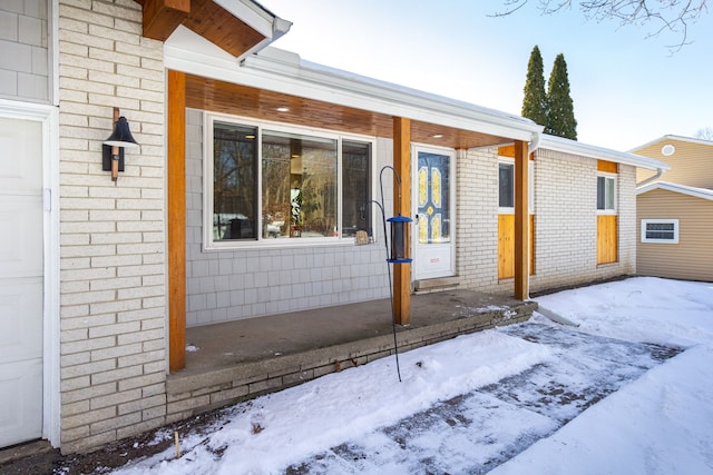 view of snow covered property entrance