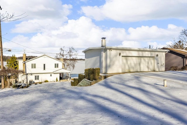 rear view of property with a garage