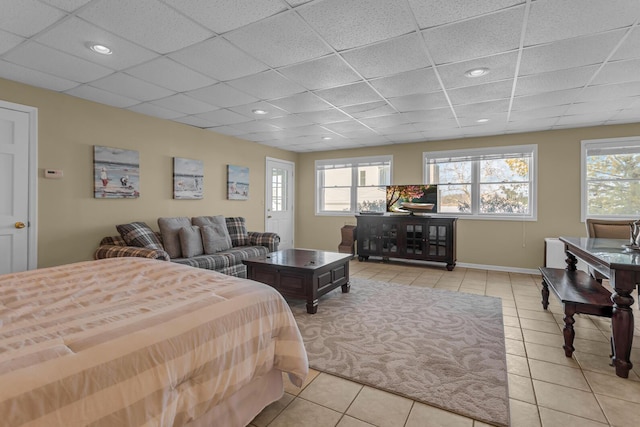 bedroom featuring light tile patterned floors and a drop ceiling