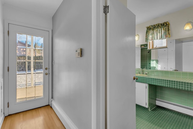 interior space featuring a baseboard radiator and sink