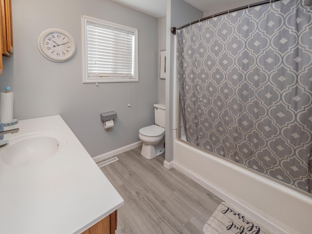 full bathroom with toilet, wood finished floors, visible vents, vanity, and shower / bathtub combination with curtain