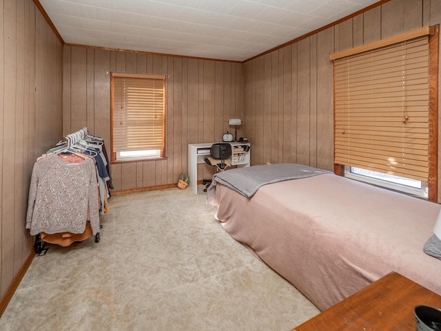 carpeted bedroom featuring wooden walls and crown molding