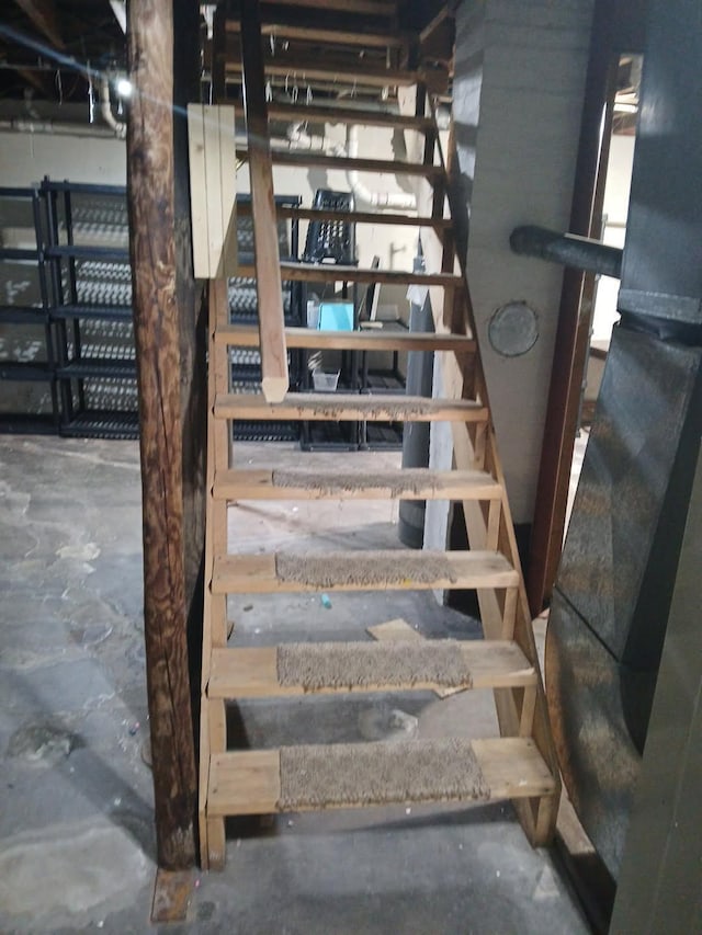 stairway featuring concrete flooring