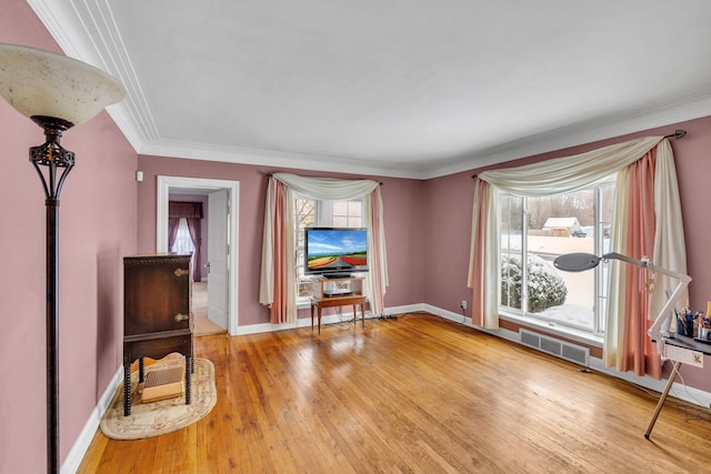 interior space with ornamental molding and hardwood / wood-style floors