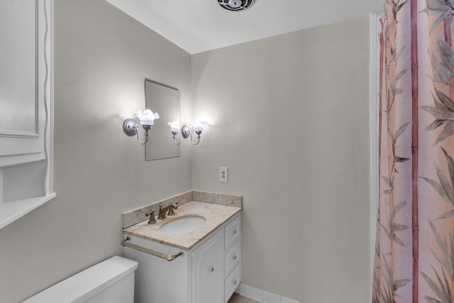 bathroom with toilet and vanity