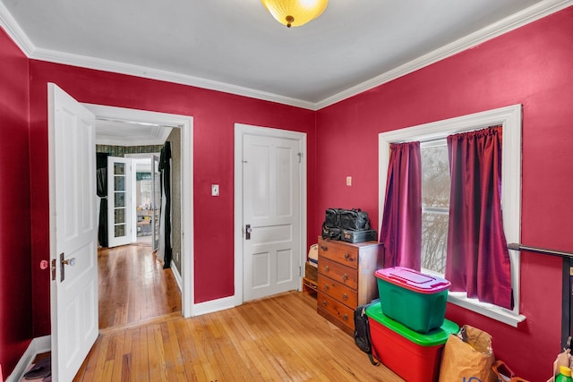 miscellaneous room with ornamental molding and light wood-type flooring