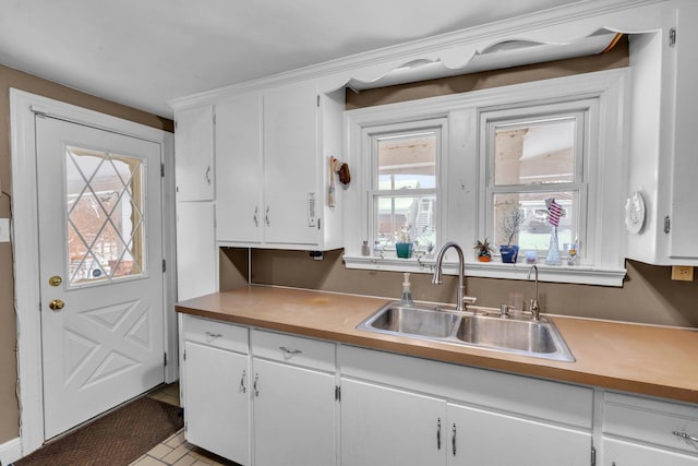 kitchen featuring sink and white cabinetry