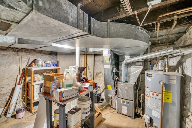 utility room featuring heating unit and gas water heater