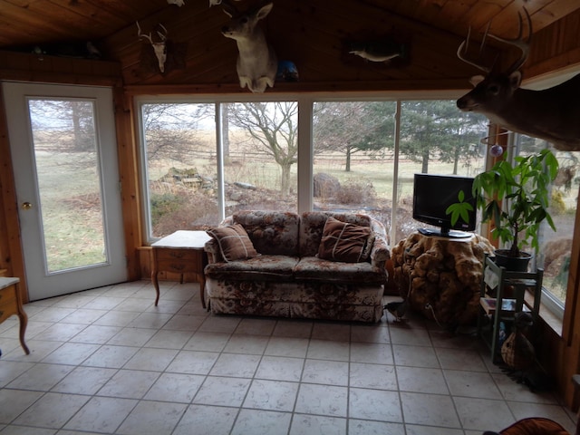 sunroom / solarium featuring lofted ceiling and wooden ceiling