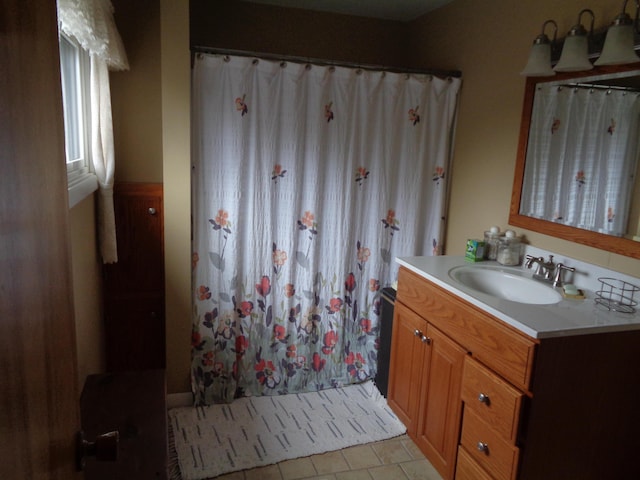 full bathroom featuring vanity, curtained shower, and tile patterned flooring