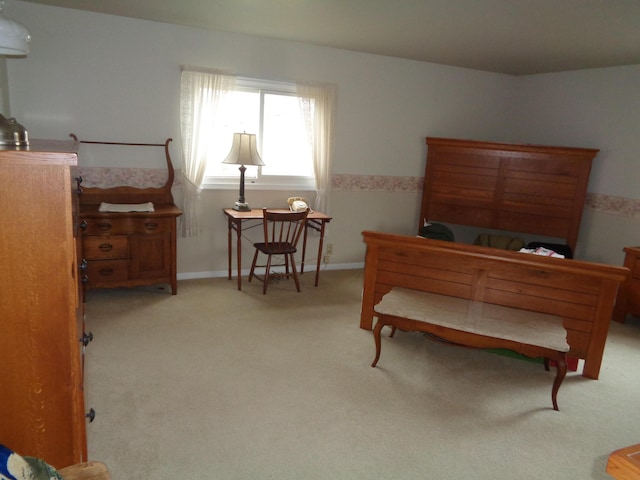 bedroom featuring light carpet and baseboards