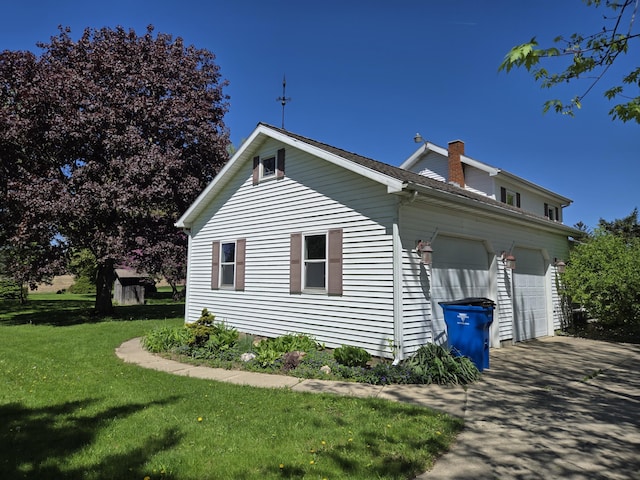 5480 E Litchfield Rd, Jonesville, MI 49250 - view of home's exterior with a lawn, a chimney, driveway, and a garage