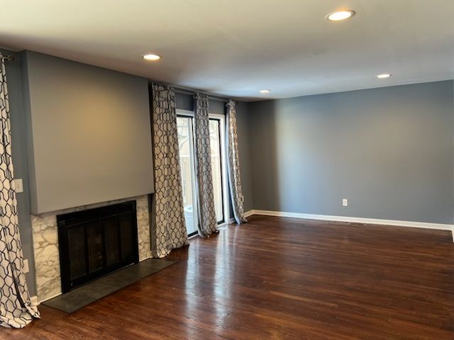 unfurnished living room with dark hardwood / wood-style floors