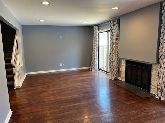 unfurnished living room featuring dark hardwood / wood-style flooring