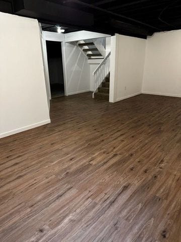 basement with dark hardwood / wood-style floors