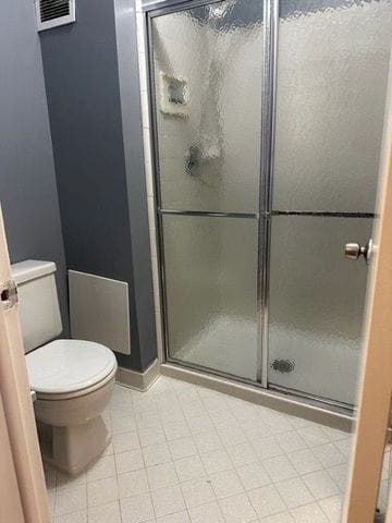 bathroom with walk in shower and toilet