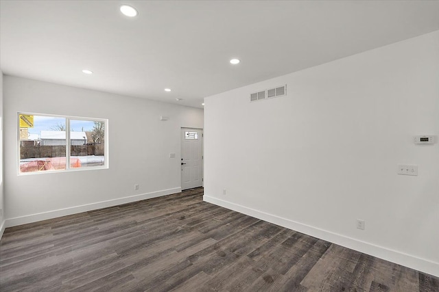 spare room featuring dark hardwood / wood-style flooring