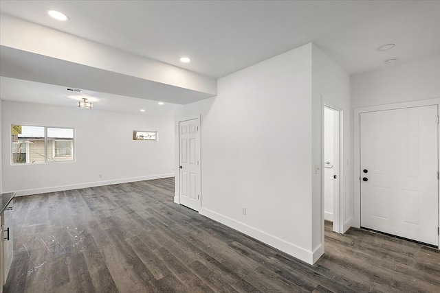 empty room with dark hardwood / wood-style flooring