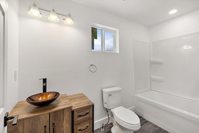 full bathroom with toilet, shower / bath combination, wood-type flooring, and vanity